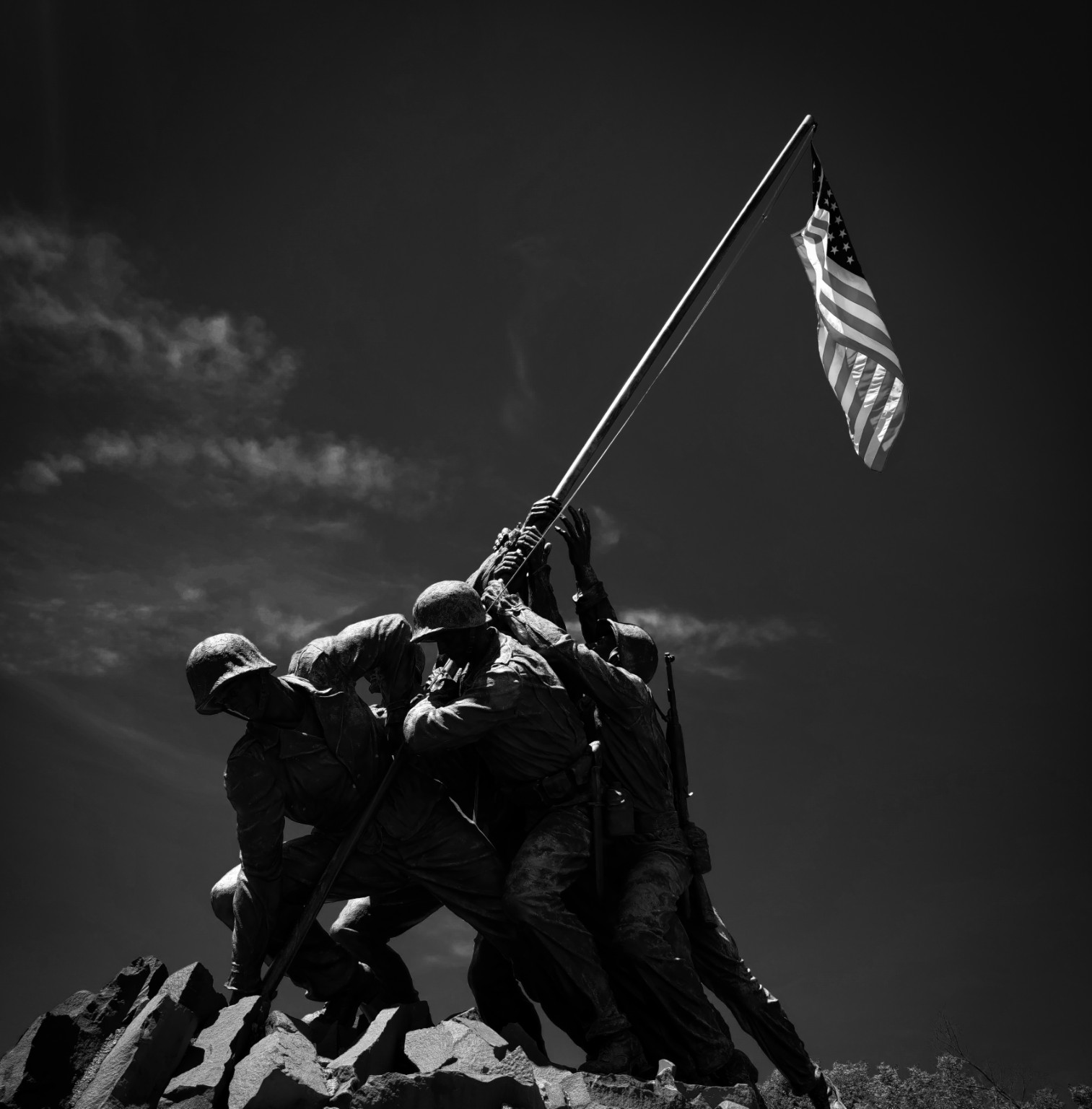 Black-and-white photograph of a flag-raising memorial