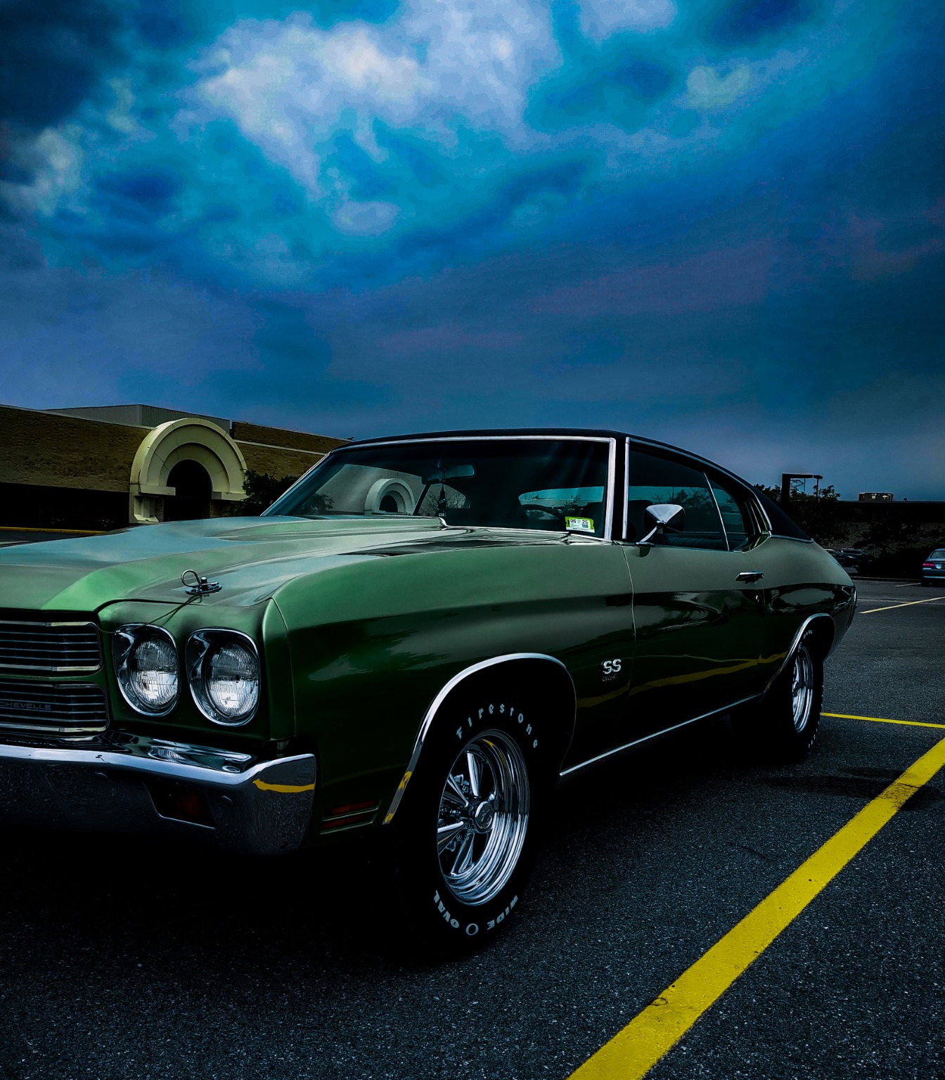 Green Chevrolet Chevelle beneath a blue sky